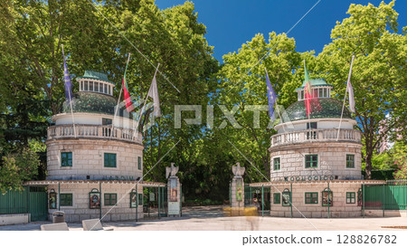 Timelapse hyperlapse of Lisbon Zoo entrance with open gates and flags on towers during summer. Lisbon, Portugal 128826782