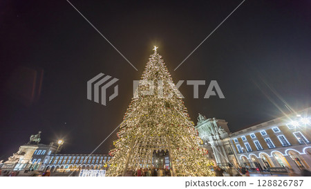 Commerce Square in Lisbon illuminated at Christmas hyperlapse, with a towering tree and crowds celebrating at night. Portugal Commerce Square in Lisbon illuminated at Christmas hyperlapse, with a towering tree and crowds celebrating at night. Portugal 128826787