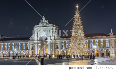 Commerce Square in Lisbon illuminated at Christmas hyperlapse, with a towering tree and crowds celebrating at night. Portugal 128826789