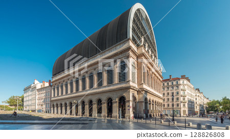 Hyperlapse of Lyon's opera house featuring neoclassical architecture combined with a modern glass dome roof. France Hyperlapse of Lyon's opera house featuring neoclassical architecture combined with a modern glass dome roof. France 128826808