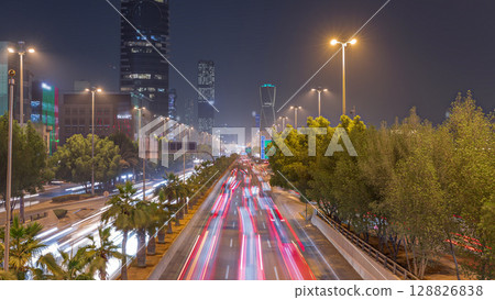 Aerial timelapse view of busy highway traffic on King Fahd Road with the iconic twisting skyscraper in Riyadh, Saudi Arabia 128826838