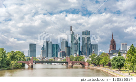 Hyperlapse of Frankfurt's skyscrapers skyline with the bell tower overlooking Alte Brucke. Frankfurt, Germany 128826854