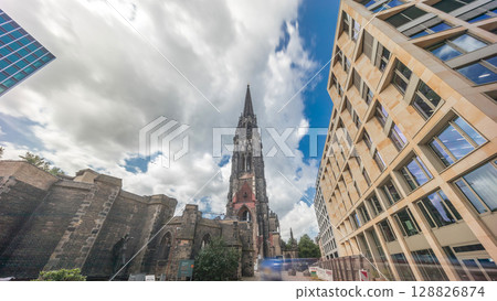 Looking up perspective to the facade of Ehemalige Hauptkirche St. Nikolai timelapse hyperlapse in Hamburg, Germany 128826874