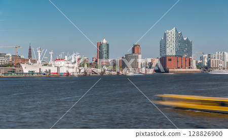 Timelapse of Hamburg's iconic Elbphilharmonie concert hall, with ships and boats in the foreground. Germany 128826900