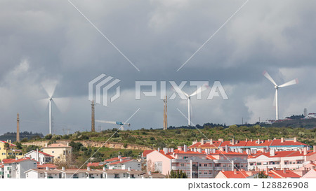 Windmills on a hill for Renewable Electrical Energy timelapse, Wind Farm Utility, Green Electric Power Generation. 128826908