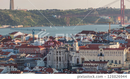 Baixa district with 25th April Bridge, Santa Justa Lift timelapse and Convento da Ordem do Carmo historical church. Lisbon 128826944