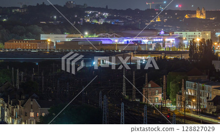 Aerial night timelapse of Brussels North station railway tracks with trains arriving and departing. Belgium 128827029