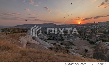 Beautiful sunrise with colorful hot air balloons take off and flying in clear morning sky aerial timelapse in Cappadocia, Turkey 128827053