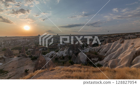 Beautiful sunrise with colorful hot air balloons take off and flying in clear morning sky aerial timelapse in Cappadocia, Turkey 128827054