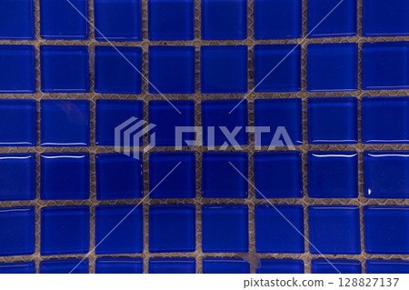 Bright blue glass tiles arranged in a distinct pattern for a creative interior design project Bright blue glass tiles arranged in a distinct pattern for a creative interior design project 128827137