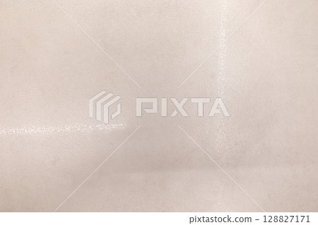 Texture of plain surface showing subtle gloss under soft lighting during indoor setting 128827171