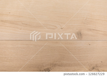 Natural wood grain flooring with a light finish showcasing unique patterns and textures Natural wood grain flooring with a light finish showcasing unique patterns and textures 128827229