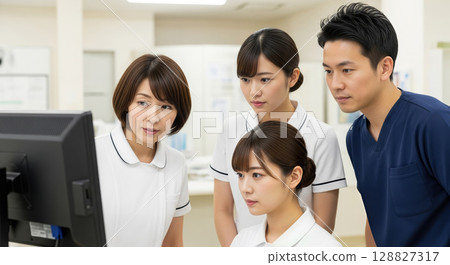 Asian nurses sharing information at the nurse station 128827317