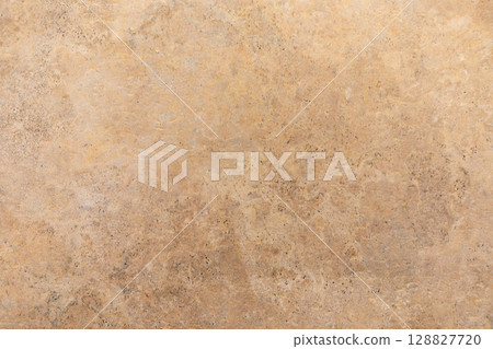 Background of textured brown surface showing natural patterns and light variations in a warm setting 128827720