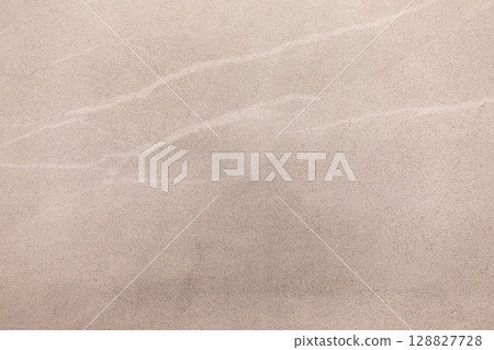 Elegant beige marble surface with subtle veining creating a soft, luxurious look for interior Elegant beige marble surface with subtle veining creating a soft, luxurious look for interior 128827728