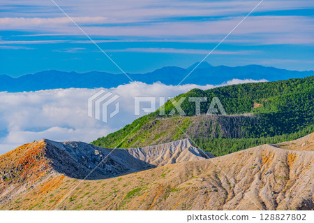 (Gunma Prefecture) Mt. Shirane crater as seen from Shibu Pass (the highest point on a national highway in Japan), with Mt. Fuji in the distance in the background (Gunma Prefecture) Mt. Shirane crater as seen from Shibu Pass (the highest point on a national highway in Japan), with Mt. Fuji in the distance in the background 128827802