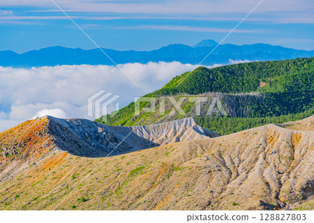 (Gunma Prefecture) Mt. Shirane crater as seen from Shibu Pass (the highest point on a national highway in Japan), with Mt. Fuji in the distance in the background (Gunma Prefecture) Mt. Shirane crater as seen from Shibu Pass (the highest point on a national highway in Japan), with Mt. Fuji in the distance in the background 128827803