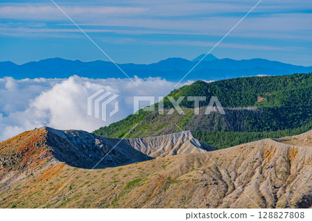 (Gunma Prefecture) Mt. Shirane crater as seen from Shibu Pass (the highest point on a national highway in Japan), with Mt. Fuji in the distance in the background 128827808
