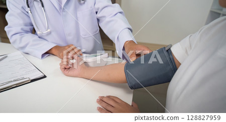 Blood Pressure Measurement. Doctor using device on patient arm. Blood Pressure Measurement. Doctor using device on patient arm. 128827959