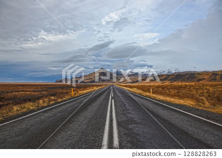 Straight road to Icelandic mountains in winter Straight road to Icelandic mountains in winter 128828263