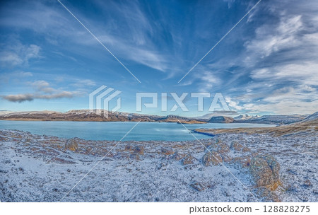 Blue lake with snowy coast and ridge in Iceland Blue lake with snowy coast and ridge in Iceland 128828275