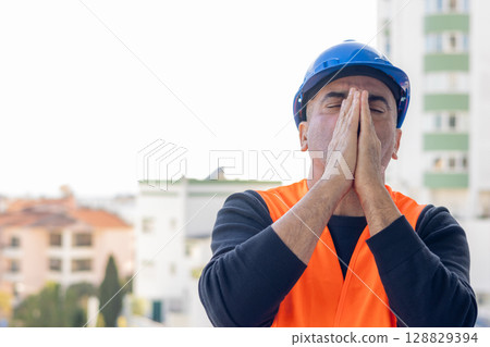 Stressed and worried mechanical technician or building contractor Stressed and worried mechanical technician or building contractor 128829394