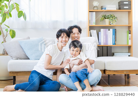 A family relaxing in the living room. 128829440