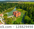 Cervena Lhota Castle, red chateau in the middle of a lake on a rocky island, South Bohemia, Czech Republic 128829498