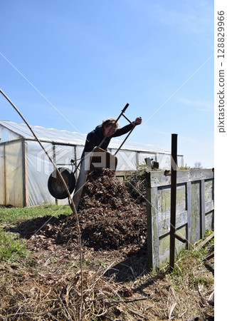 Young man engaged in household chores and small-scale rural farming, tending to his garden with care and dedication. His daily routine reflects a sustainable and self-sufficient way of life 128829966