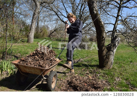 Young man engaged in household chores and small-scale rural farming, tending to his garden with care and dedication. His daily routine reflects a sustainable and self-sufficient way of life 128830028