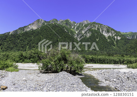 Summer scenery of Kamikochi with the majestic mountains of the Hotaka mountain range and riverbanks Summer scenery of Kamikochi with the majestic mountains of the Hotaka mountain range and riverbanks 128830151
