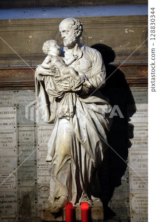 Saint Joseph holding child Jesus, statue in the Saint Sulpice Church, Paris, France Saint Joseph holding child Jesus, statue in the Saint Sulpice Church, Paris, France 128830344