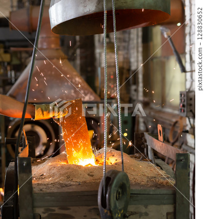 Foundry - ferrous metal is melted in an induction furnace of metallurgical plant Foundry - ferrous metal is melted in an induction furnace of metallurgical plant 128830652