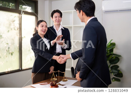 Legal Professionals Celebrating Successful Agreement in Office 128831049
