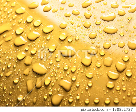 Image of water droplets and a water-repellent car hood (yellow) 128831727