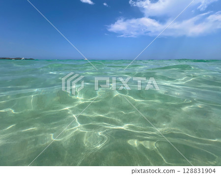 The beach Spiaggia La Cinta in San Teodoro, Olbia, Sardinia. Sea water close up The beach Spiaggia La Cinta in San Teodoro, Olbia, Sardinia. Sea water close up 128831904