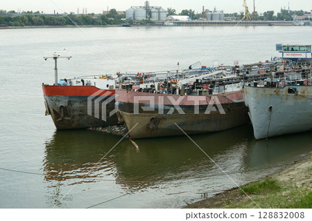 Rusty Barges and Floating Trash on Danube River Rusty Barges and Floating Trash on Danube River 128832008