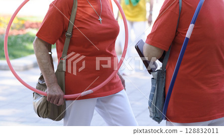 Senior Exercise with Hula Hoop and Pole in Park 128832011
