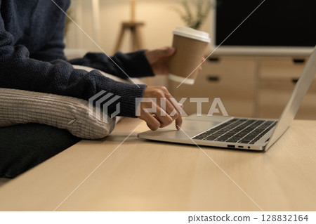 Young Asian woman enjoying a peaceful moment reading a book near window. Calm lifestyle, self-learning, and mindfulness at home. 128832164