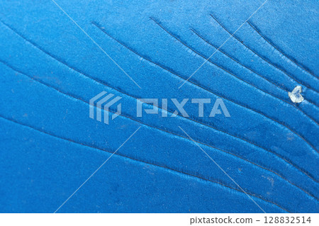 Close up of blue textured surface with intricate line patterns and small Close up of blue textured surface with intricate line patterns and small 128832514