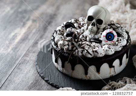 Spooky Halloween chocolate Cake with Skull, Eyeball, and Spider Decoration 128832757