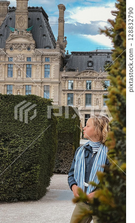 Girl Exploring Urban Garden Near Historic Building 128832790