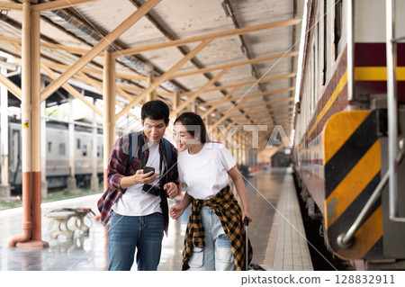 Couple enjoying travel moments at train station 128832911
