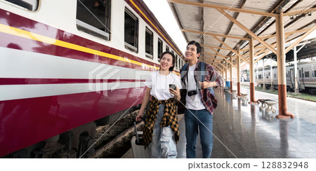 Couple walking together, enjoying travel moments at the station 128832948