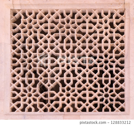 Beautiful stone carvings on the wall in Fatehpur Sikri complex, Uttar Pradesh, India 128833212