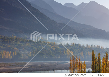 The autumn scenery with Hindu Kush mountain range in the background is very beautiful, Gahkuch,northern Pakistan. 128833229