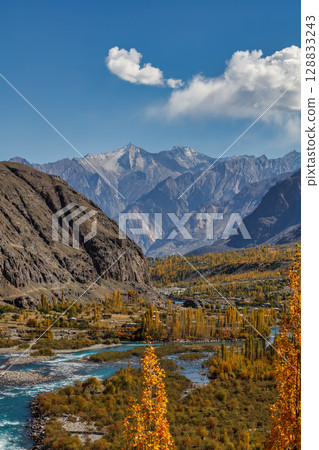 The autumn scenery with Hindu Kush mountain range in the background is very beautiful, Gahkuch,northern Pakistan. The autumn scenery with Hindu Kush mountain range in the background is very beautiful, Gahkuch,northern Pakistan. 128833243