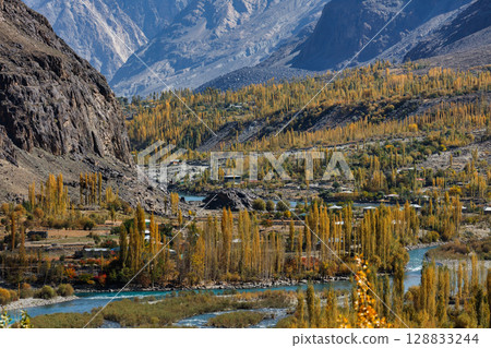 The autumn scenery with Hindu Kush mountain range in the background is very beautiful, Gahkuch,northern Pakistan. The autumn scenery with Hindu Kush mountain range in the background is very beautiful, Gahkuch,northern Pakistan. 128833244