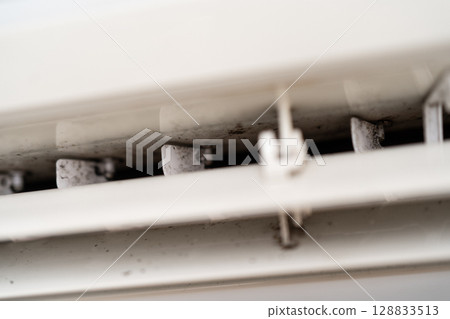 Mold on air conditioner close-up. Air conditioner maintenance and cleaning. Mold on air conditioner close-up. Air conditioner maintenance and cleaning. 128833513