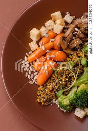 Food bowl with tofu, quinoa, broccoli and carrots, microgreens 128834036